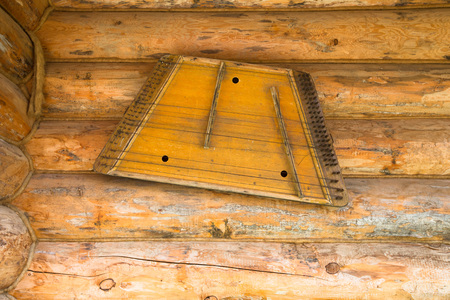 Ancient musical instrument gusli on the wooden wall.の写真素材