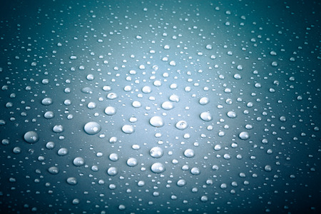 Drops of water on the colored background.の写真素材