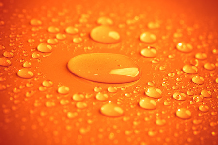 Drops of water on the colored background.の写真素材