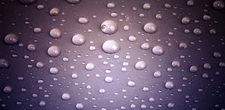 Drops of water on the colored background.の写真素材