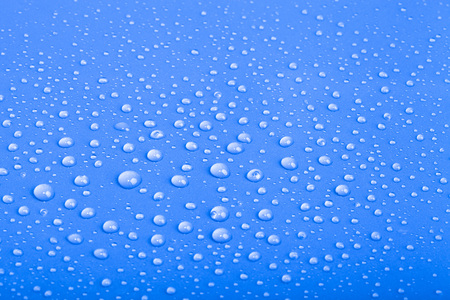 Drops of water on the colored background.の写真素材