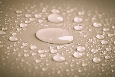 Drops of water on the colored background.の写真素材