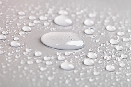 Drops of water on the colored background.の写真素材
