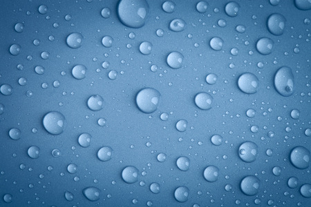 Drops of water on the colored background.の写真素材