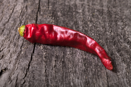 Red hot chili peppers on old wooden tableの写真素材