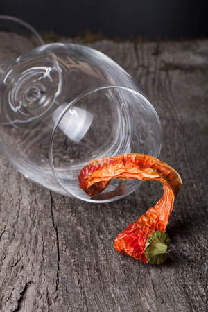 red hot chili peppers in a glass on a dark wooden backgroundの写真素材