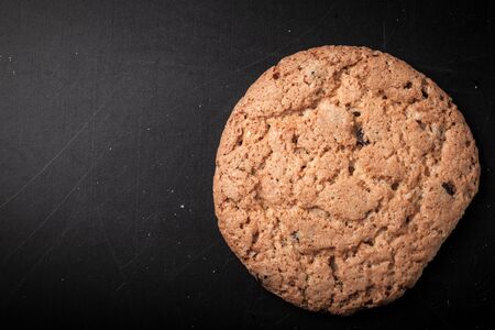 Oat cookies on the old shabby background. tinted. with space for textの写真素材