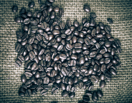 Coffee beans on sackcloth background. の写真素材
