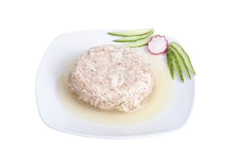 Jellied meat with vegetables on a white dish.の写真素材
