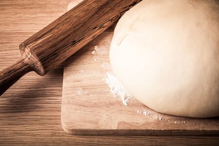 rolling pin and dough on a wooden table. slightly tintedの写真素材