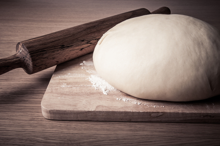 rolling pin and dough on a wooden table. slightly tintedの写真素材