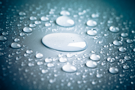 Drops of water on the colored background.の写真素材