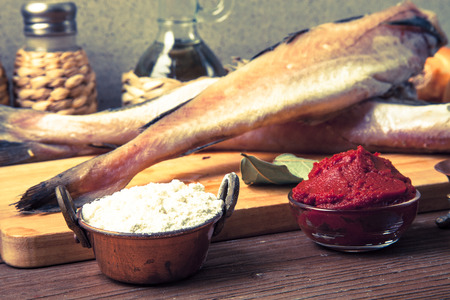 Fresh fish, vegetables, flour, tomatoe paste and spices on a wooden board. Toned.の写真素材