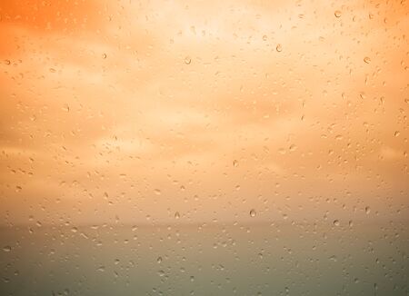 Seaview through the raindrops on window. Toned.の写真素材
