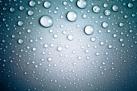 Drops of water on the colored background.の写真素材