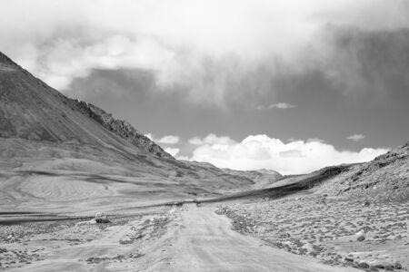 Road to clouds in valley in the foothills of the Fann mountains. Landscape. Toned.の写真素材
