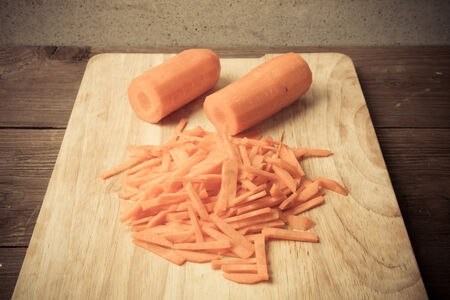 Sliced carrots on a wooden cutting board. Toned.の写真素材