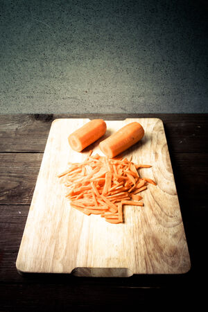Sliced carrots on a wooden cutting board. Toned.の写真素材