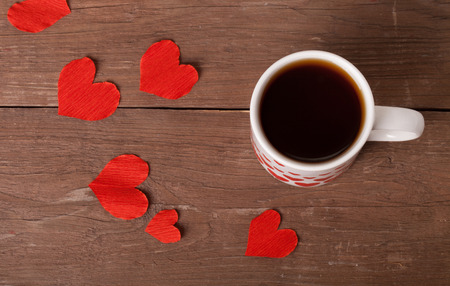 Valentine hearts and cup of tea on the old wooden table.の写真素材
