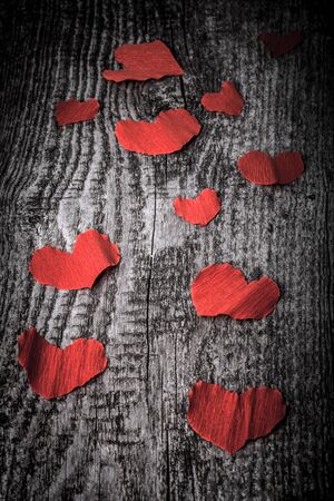 Many Valentine hearts on the old wooden table. Toned.の写真素材