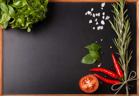 Herbs and spices. basil, red pepper, salt and rosemary on a black background. With space for textの写真素材