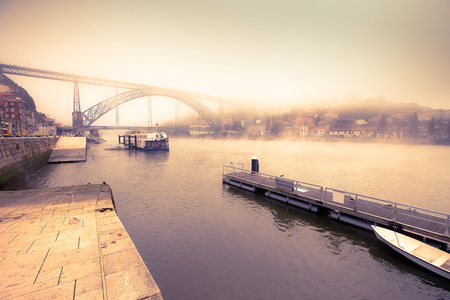 View of the River Douro and the metal bridge of Don Luis in Porto. The fog. Toned.の写真素材
