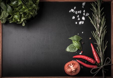 Herbs and spices. basil, red pepper, salt and rosemary on a black background. With space for textの写真素材