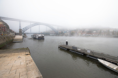 View of the River Douro and the metal bridge of Don Luis in Porto. The fog.の写真素材