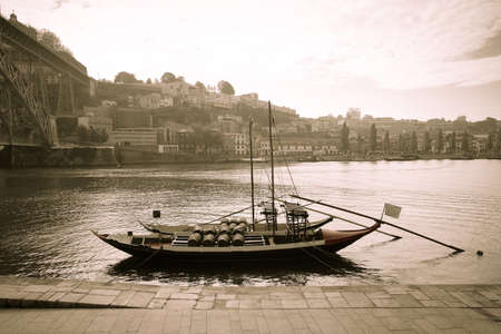 Boat with barrels of wine at the berth. Douro River. city of Porto. Toned.のeditorial素材