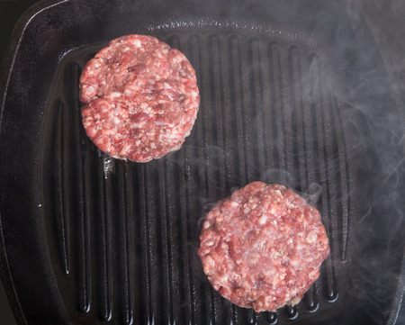 Fresh meat cutlets in a frying pan grill.の写真素材