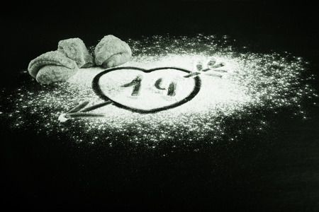drawing a heart with an arrow on the flour and cookies to happiness. tintedの写真素材