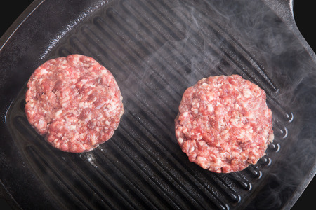 Fresh meat cutlets in a frying pan grill.の写真素材