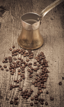 Coffee turk and coffee beans on old gray wooden table. Toned.の写真素材