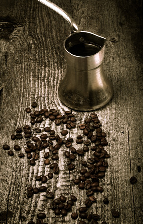 Coffee turk and coffee beans on old gray wooden table. Toned.の写真素材