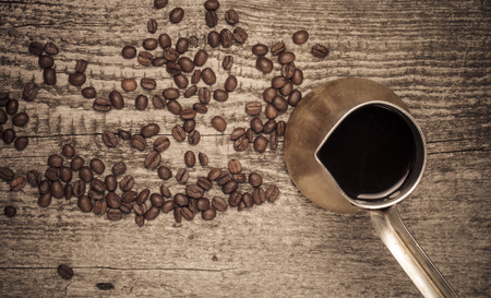 Coffee turk and coffee beans on old gray wooden table. Toned.の写真素材