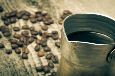 Coffee turk and coffee beans on old gray wooden table. Toned.の写真素材