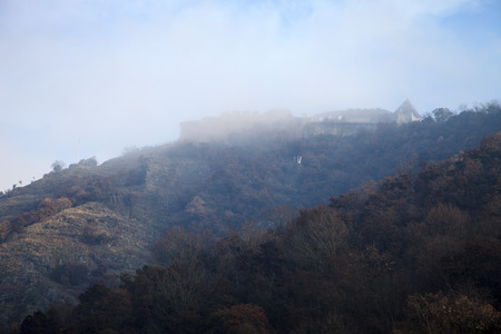 Castle on a wooded hill in the fog. Landscape.のeditorial素材