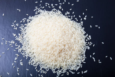 Handful rice on a black background.の写真素材