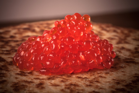 Red caviar on Russian pancakes - blini. Toned.の写真素材