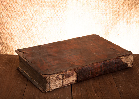 Ancient book on the old wooden table.の写真素材
