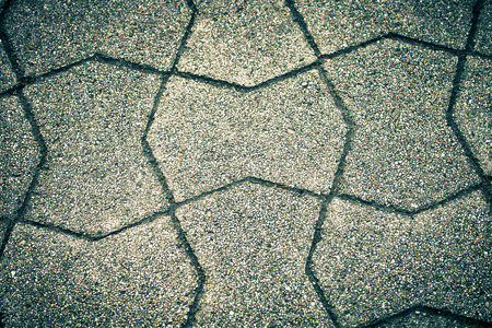 Sidewalk tile made of natural stones. Background. Toned.の写真素材