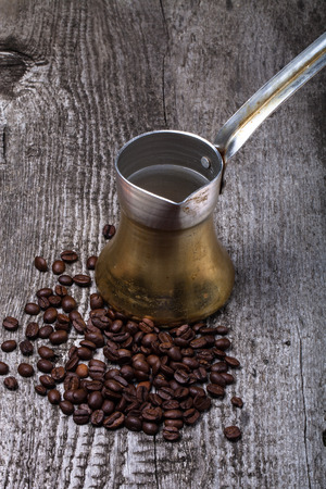 Coffee turk and coffee beans on old gray wooden table.の写真素材