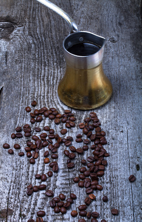 Coffee turk and coffee beans on old gray wooden table.の写真素材