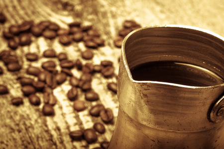 Coffee turk and coffee beans on old gray wooden table. Toned.の写真素材