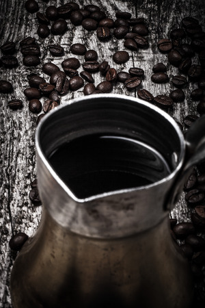Coffee turk and coffee beans on old gray wooden table. Toned.の写真素材