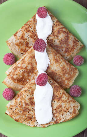 Russian pancakes - blini with sour cream and raspberry.の写真素材