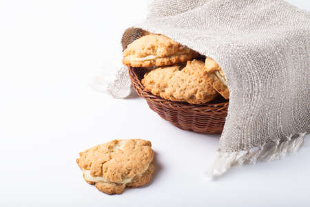 Basket of cookies with cottage cheese - sochnik on a light background.の写真素材