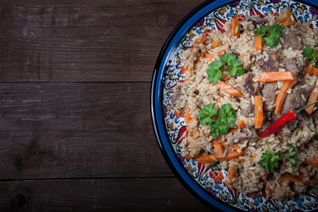 Delicious pilaf on a turkish plate on old wooden table. Rustic style. Toned.の写真素材