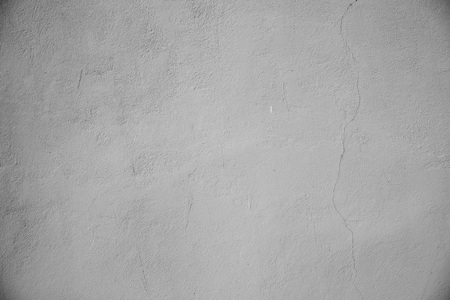 Plastered wall with a vertical crack. Background. Toned gray.の写真素材