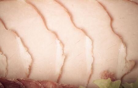 Slices of ham and salad leaf. Toned.の写真素材